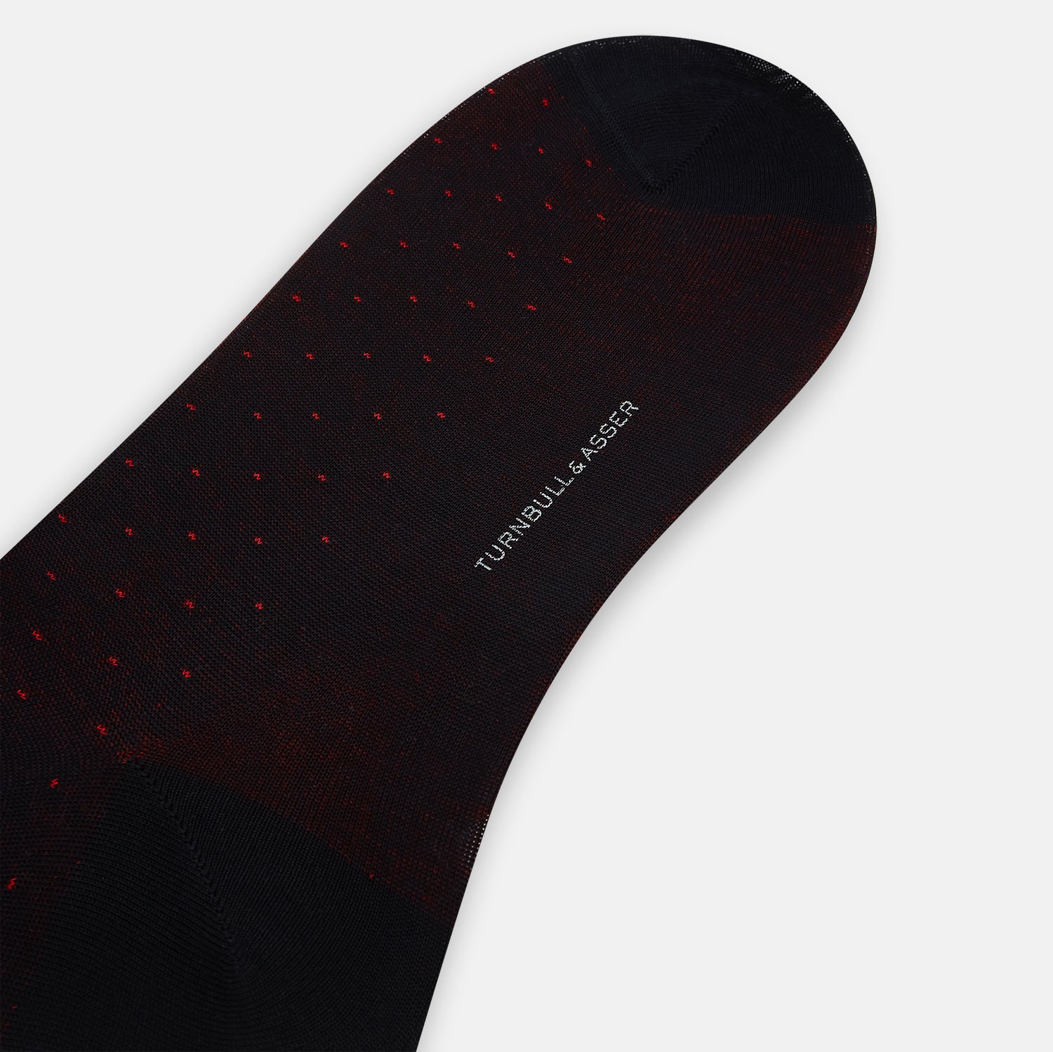 View 3 of product The Turnbull & Asser Navy/Red Polka Dot Mid-Length Sock is shown against a white background, featuring small red dots and solid black cuff, heel, and toe for classic style.