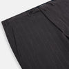 View 2 of product Turnbull & Asser’s Dark Chocolate Striped Edmund trousers feature straight-cut legs, a relaxed fit, button closure, and belt loops. These cotton trousers display subtle vertical stripes against a plain white background.