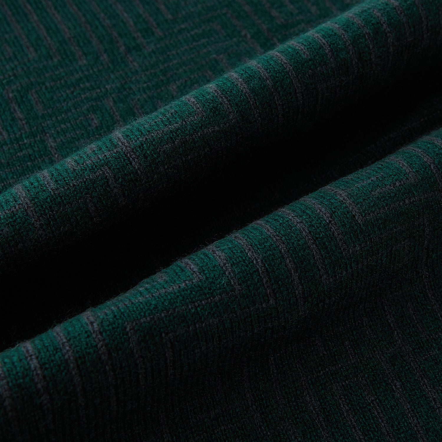 Image 3 of product The Turnbull & Asser Forest Green and Charcoal Fretwork Cashmere Knitted Scarf, featuring a subtle geometric pattern, is neatly folded and knotted against a plain white background.