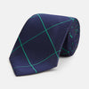 View 1 of product The Turnbull & Asser Green and Navy Window Pane Silk Tie features a subtle ribbed texture with a diagonal green grid pattern, inspired by archival designs—a stylish choice for modern office attire.