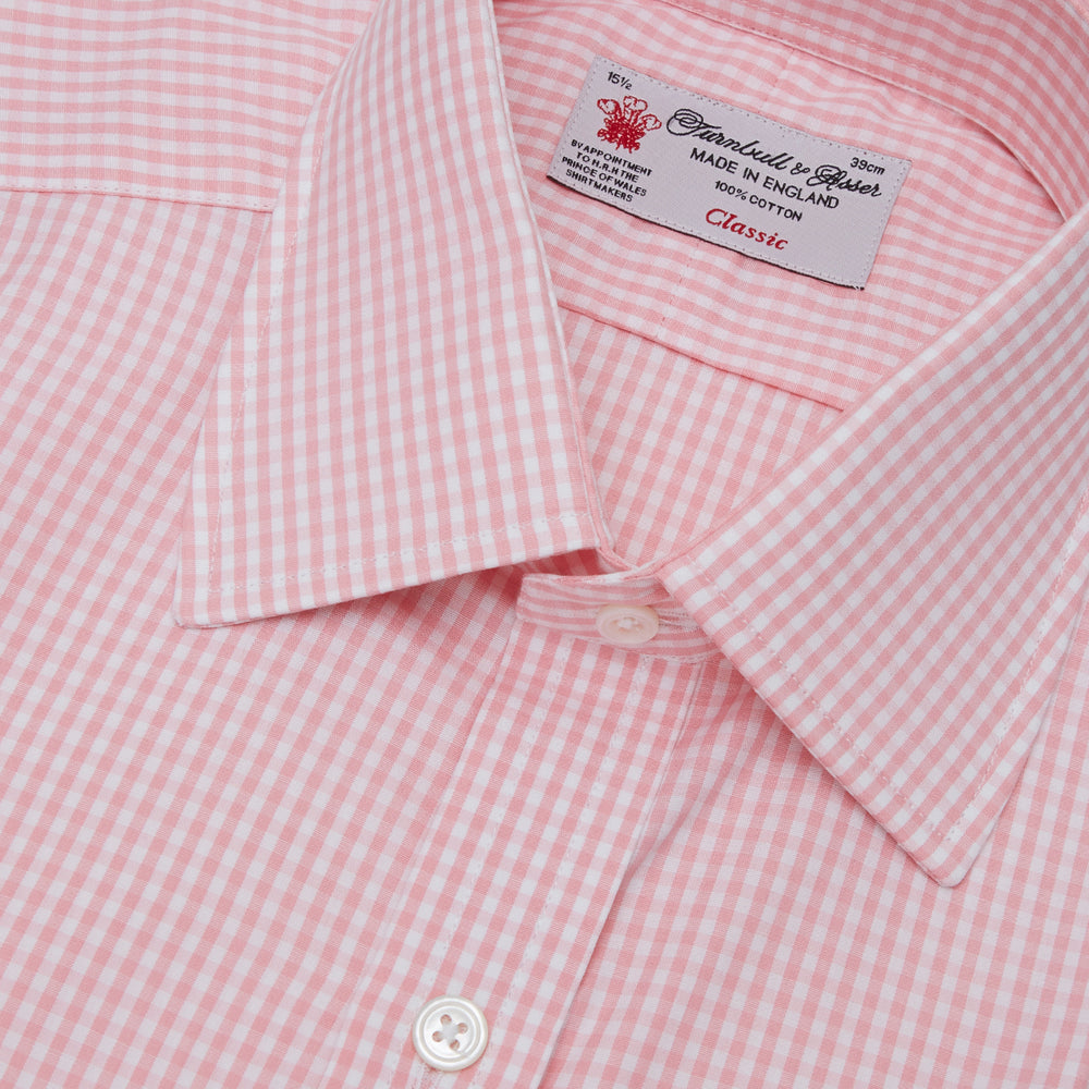 The Turnbull & Asser Light Pink Gingham Check Shirt features a classic T&A collar, 3-button cuffs, and white buttons, neatly folded on a plain white background.