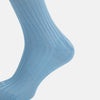 View 4 of product A single Turnbull & Asser Pale Blue Long Sock, featuring a ribbed texture and crafted from mercerised Egyptian cotton, is displayed upright on a plain white background.