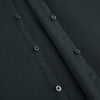 View 7 of product The Charcoal Windsor Shirt by Turnbull & Asser is a black, long-sleeve button-up with a pointed Windsor collar, buttoned cuffs, and a straight hem, shown flat on a white background.