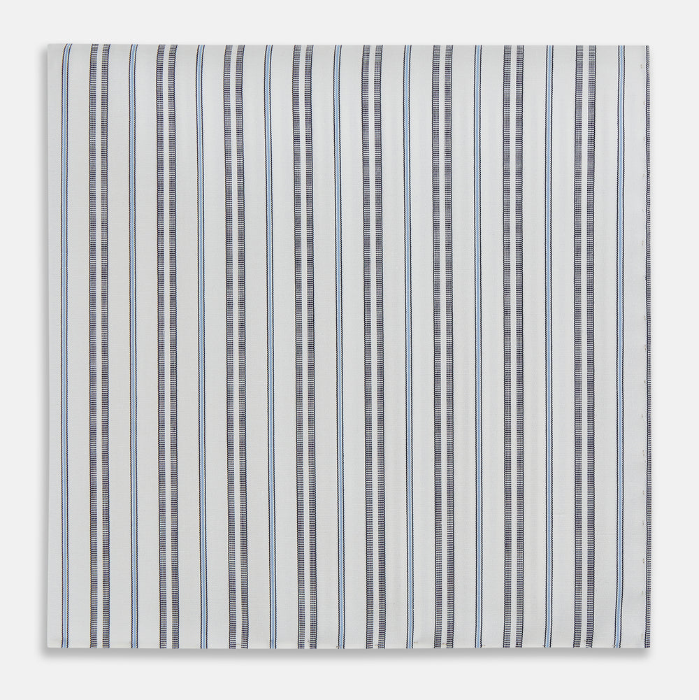 The Turnbull & Asser Navy and Light Blue Track Stripe Hand-Rolled Handkerchief features vertical stripes in blue, black, and gray on white with hand-rolled edges, expertly crafted in England.