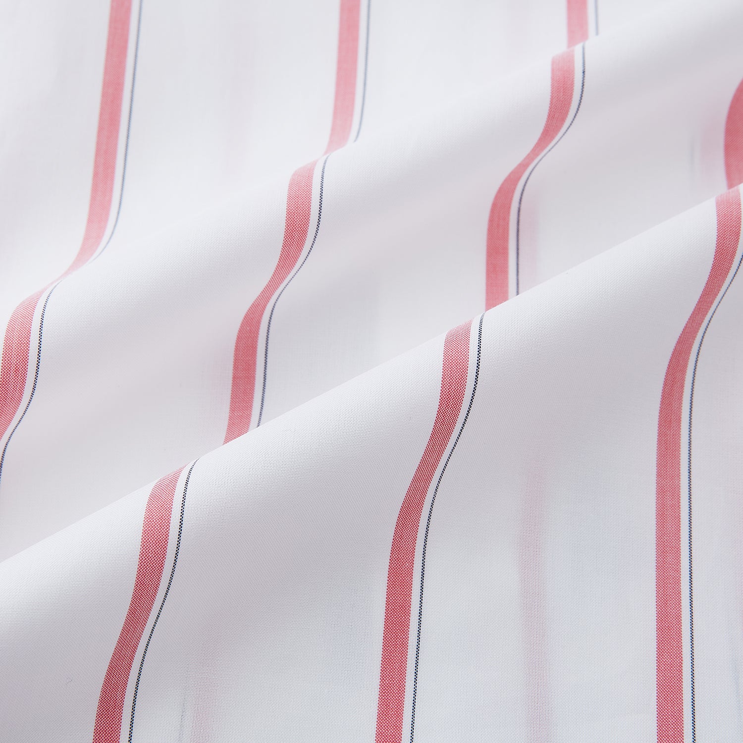 View 6 of product The Turnbull & Asser Coral Track Stripe Mayfair Shirt features a white Italian cotton fabric with vertical red stripes and a pointed T&A collar, shown against a plain light background.