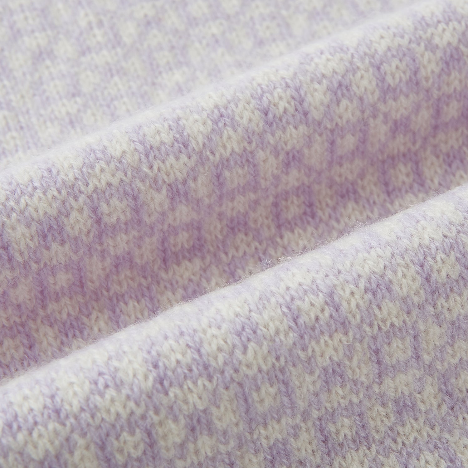 Image 3 of product The Turnbull & Asser Ivory and Lilac Lozenge-Patterned Cashmere Knitted Scarf, tied loosely, reveals its refined style and geometric design against a plain white background.