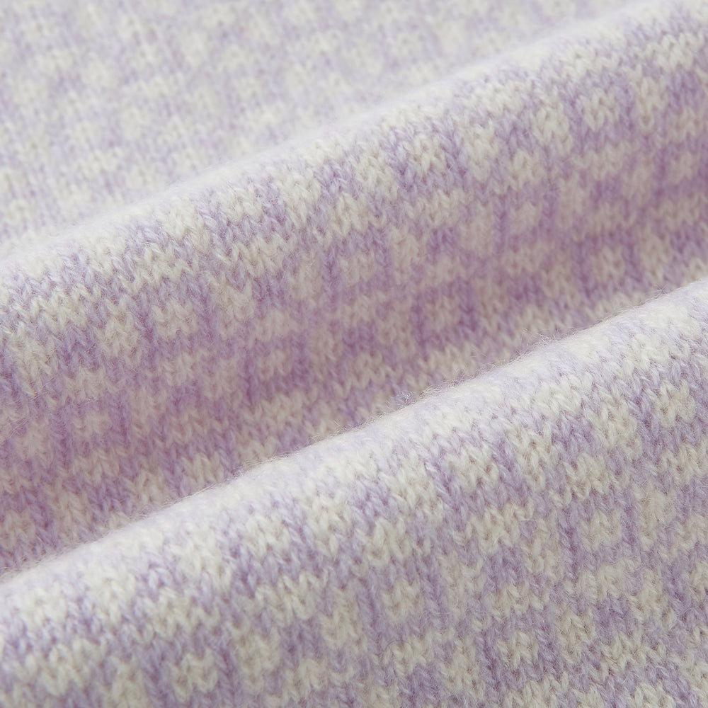 The Turnbull & Asser Ivory and Lilac Lozenge-Patterned Cashmere Knitted Scarf, tied loosely, reveals its refined style and geometric design against a plain white background.