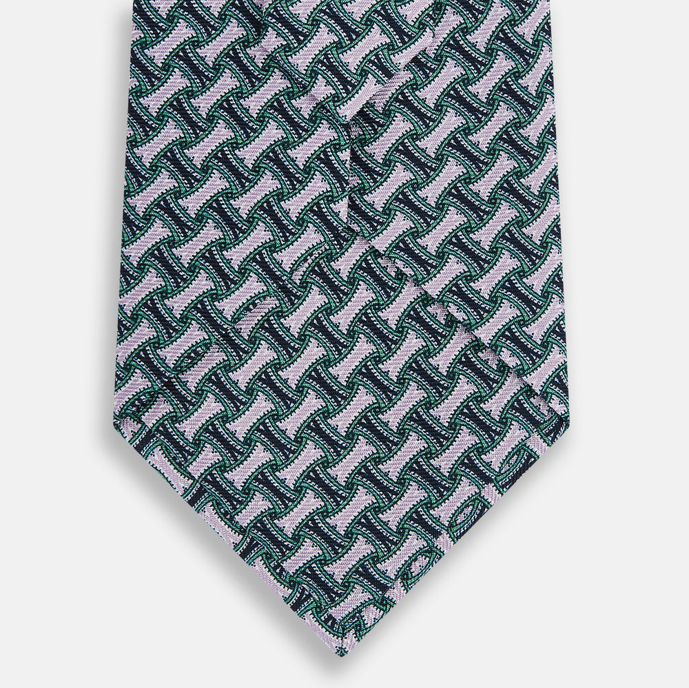 The Turnbull & Asser Lilac and Kelly Weave-Patterned Printed Silk Tie features an elegant geometric design in green, white, and pink on a white background, crafted from English silk with a textured look and classic pointed end.