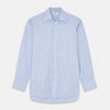 View 2 of product Close-up of Turnbull & Asser's Pale Blue Multi-stripe Cotton Fabric, featuring diagonal white, navy, and tan stripes displayed in a circular frame against a plain white background.
