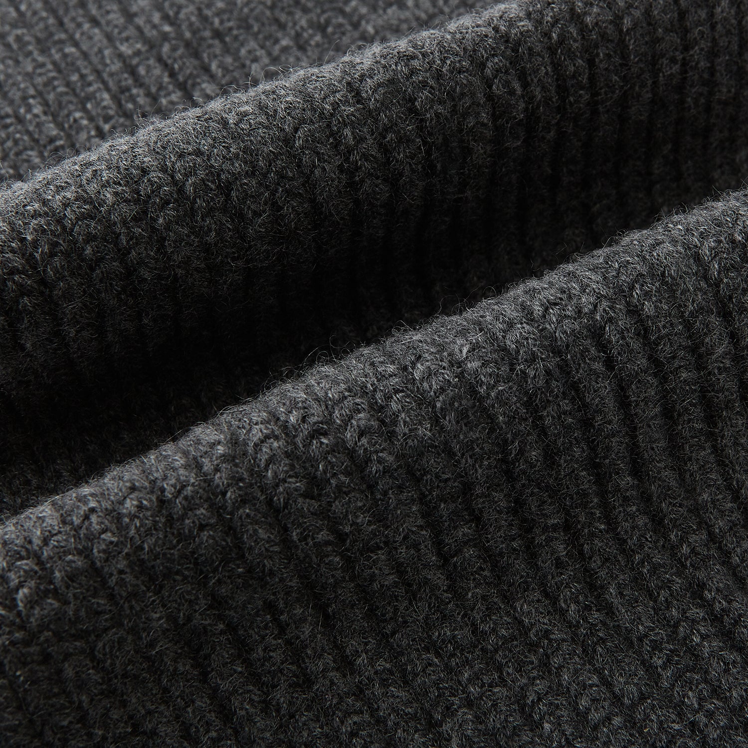 Image 3 of product The Turnbull & Asser Graphite Rib-Knit Cashmere Scarf, a luxury winter accessory, is shown neatly looped against a plain white background.