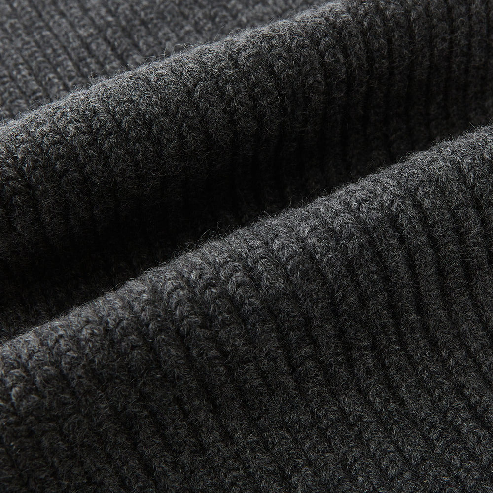 The Turnbull & Asser Graphite Rib-Knit Cashmere Scarf, a luxury winter accessory, is shown neatly looped against a plain white background.