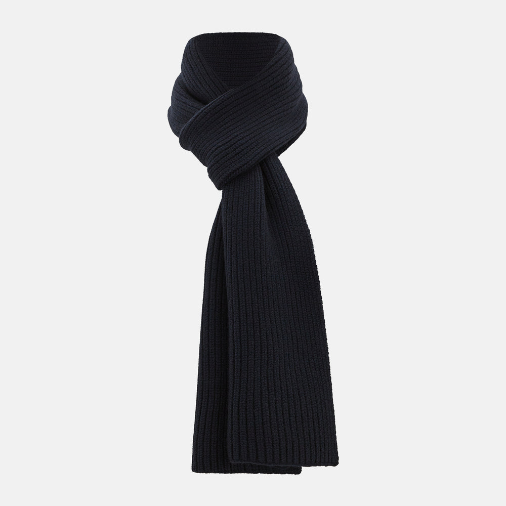 The Navy Rib-Knit Cashmere Scarf by Turnbull & Asser is neatly folded and looped in a simple knot against a white background, highlighting its refined luxury appeal.