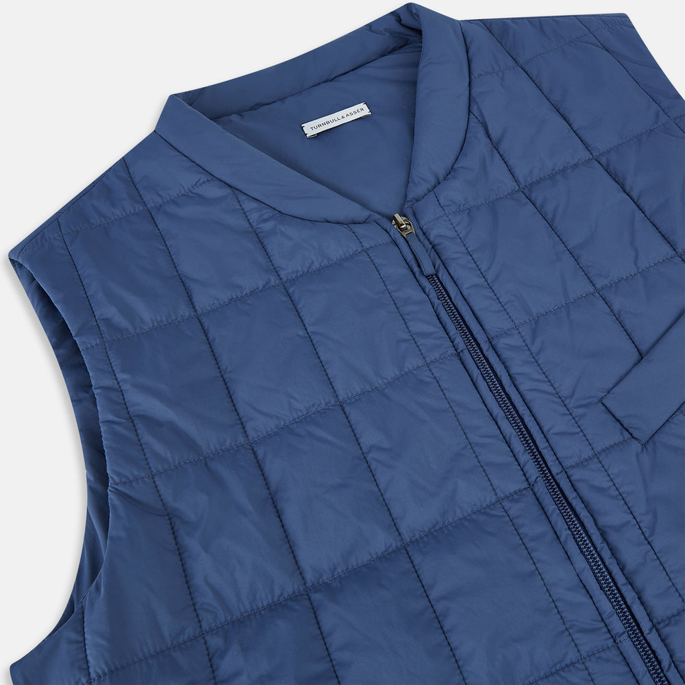 The Azzurro Quilted Gilet by Turnbull & Asser is a sleeveless, lightweight men’s outerwear piece featuring a front zipper, angled zippered pockets, and a chest pocket, shown against a plain white background.