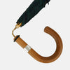View 4 of product The Turnbull & Asser Black Watch Tartan Traveller Umbrella features a Malacca crook handle and a dark green and navy blue plaid canopy, shown against a plain white background.