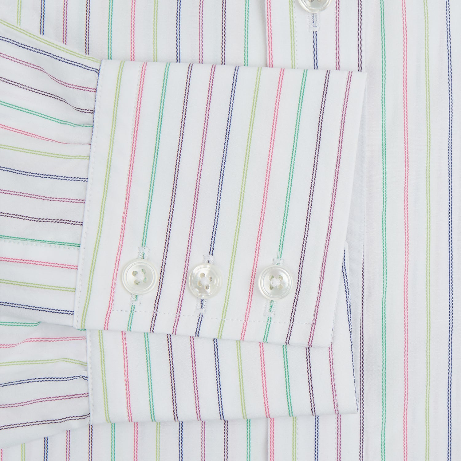 View 4 of product The Turnbull & Asser Multicoloured Double Pinstripe Mayfair Shirt, made from organic cotton, features thin blue, green, and pink stripes on white and is displayed laid flat on a white surface.