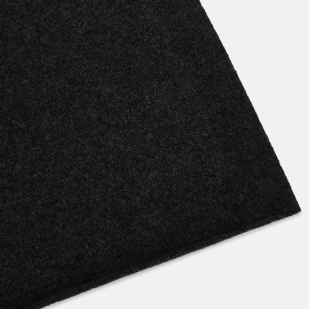 The Turnbull & Asser Plain Charcoal Cashmere Knitted Scarf, shown tied simply against a white background, is a classic luxury accessory perfect for any wardrobe.