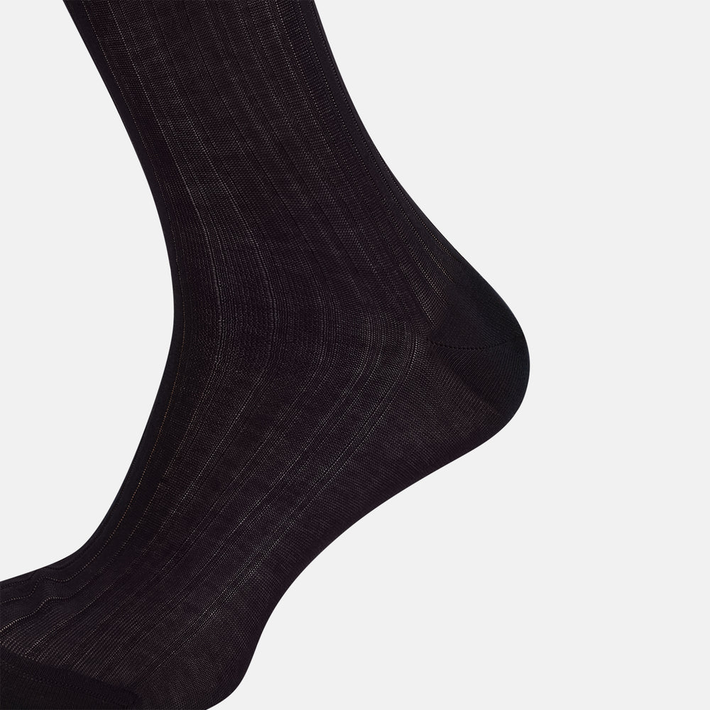 A single Midnight Blue Long Sock by Turnbull & Asser is shown on a white background, showcasing a ribbed texture and a fitted design that extends from the foot to the top of the calf.