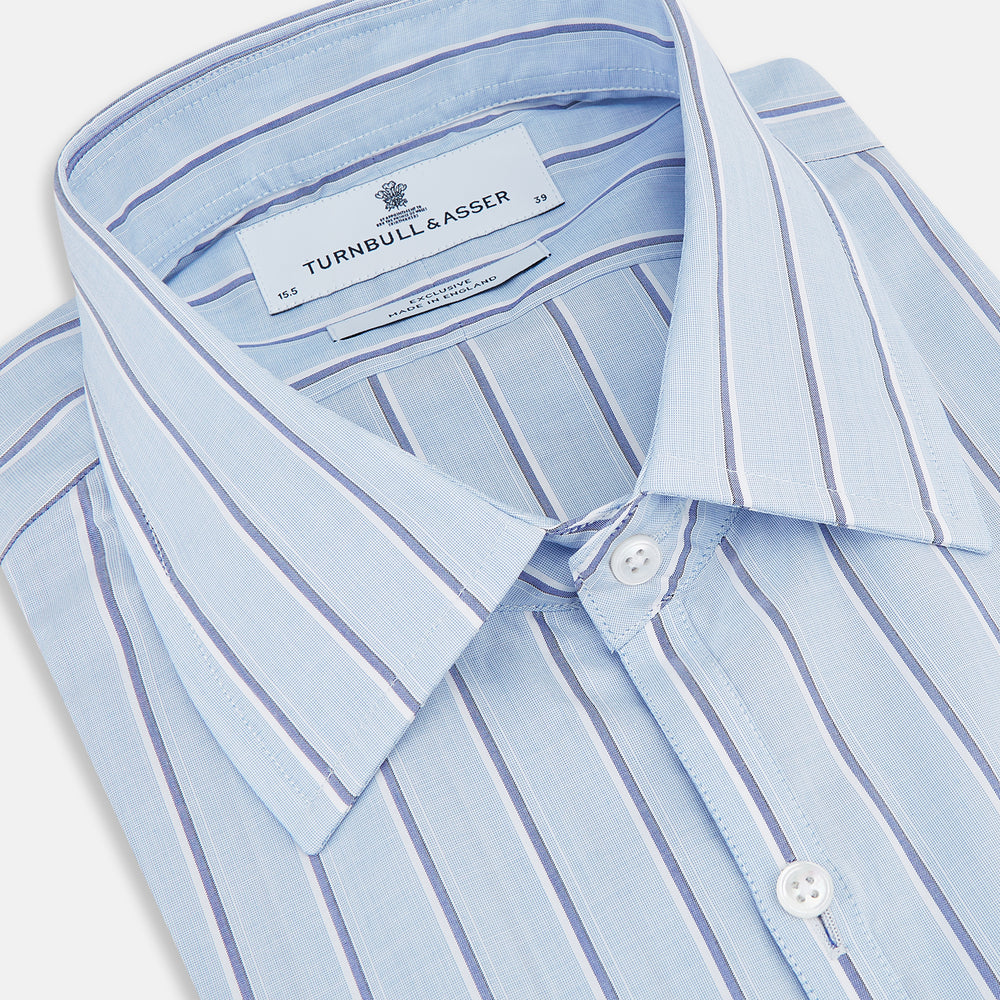 The Blue and Navy Multi-Stripe Westminster Shirt by Turnbull & Asser, featuring bold vertical stripes and a classic collar, exemplifies British craftsmanship and is shown laid flat on a white background.