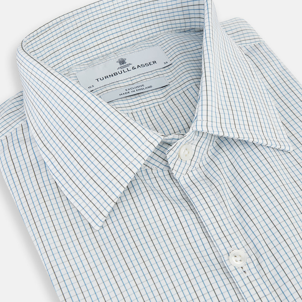 The Pale Blue and Navy Grid Check Westminster Shirt by Turnbull & Asser features a button-down front and pointed collar, highlighting fine British craftsmanship, displayed on a white background.