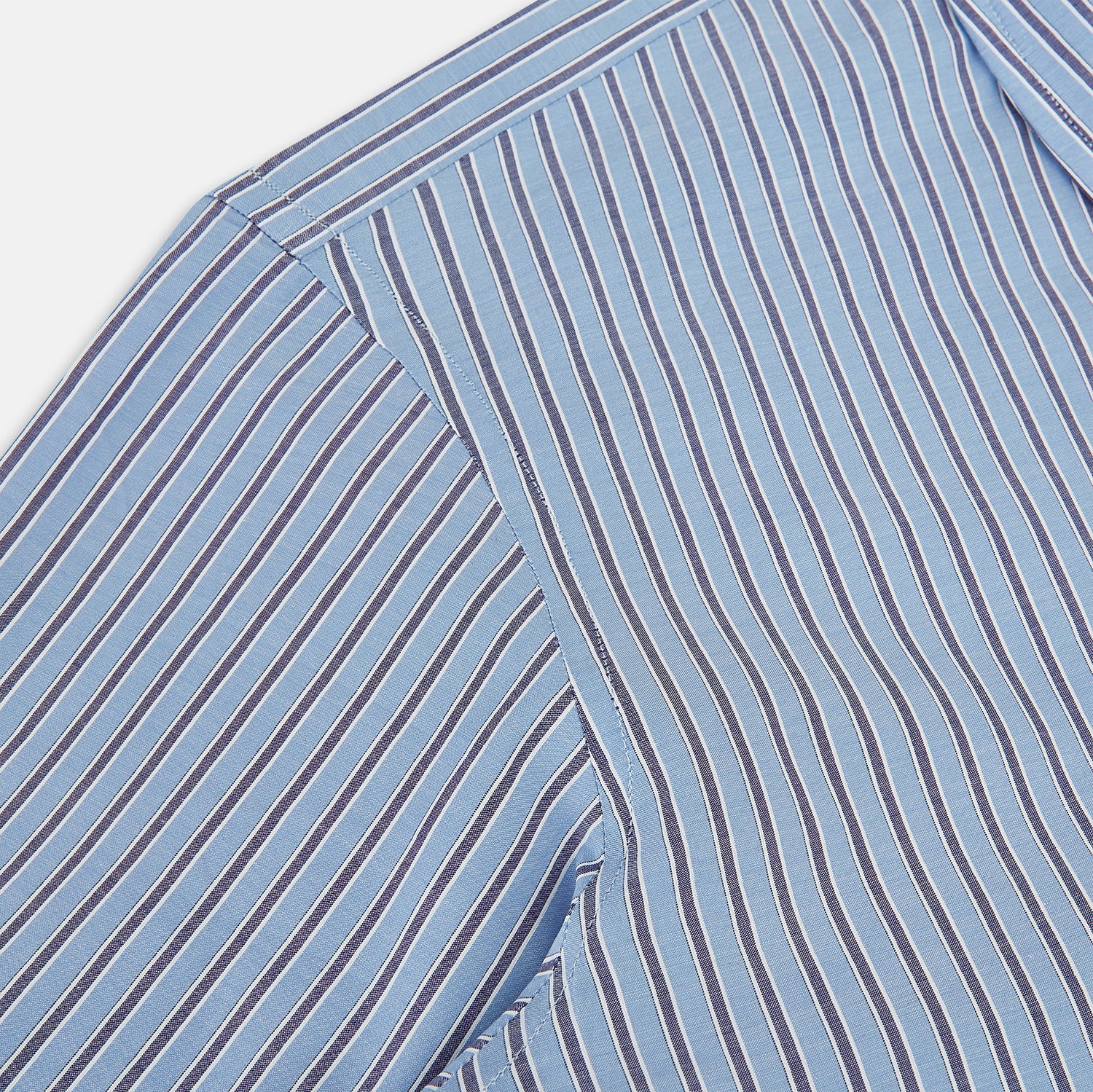 Image 6 of product The Steel Blue Ticking Stripe Westminster Shirt by Turnbull & Asser features a classic fit, Turnbull collar, vertical stripes, white buttons, and buttoned cuffs—showcasing refined British craftsmanship.