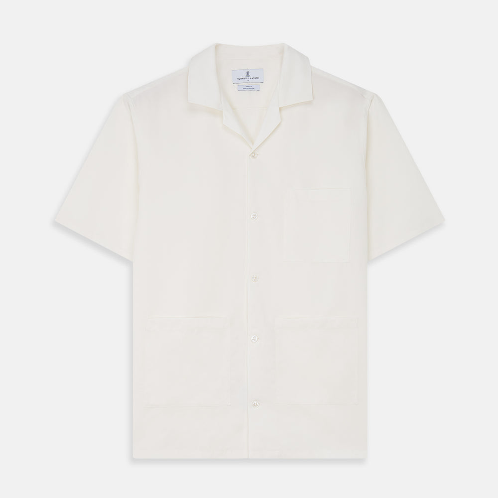The Cream Silk Holiday Fit Phillips Shirt by Turnbull & Asser is a short-sleeved, collared silk shirt in off-white with three front pockets and a revere collar, displayed flat on a plain white background.