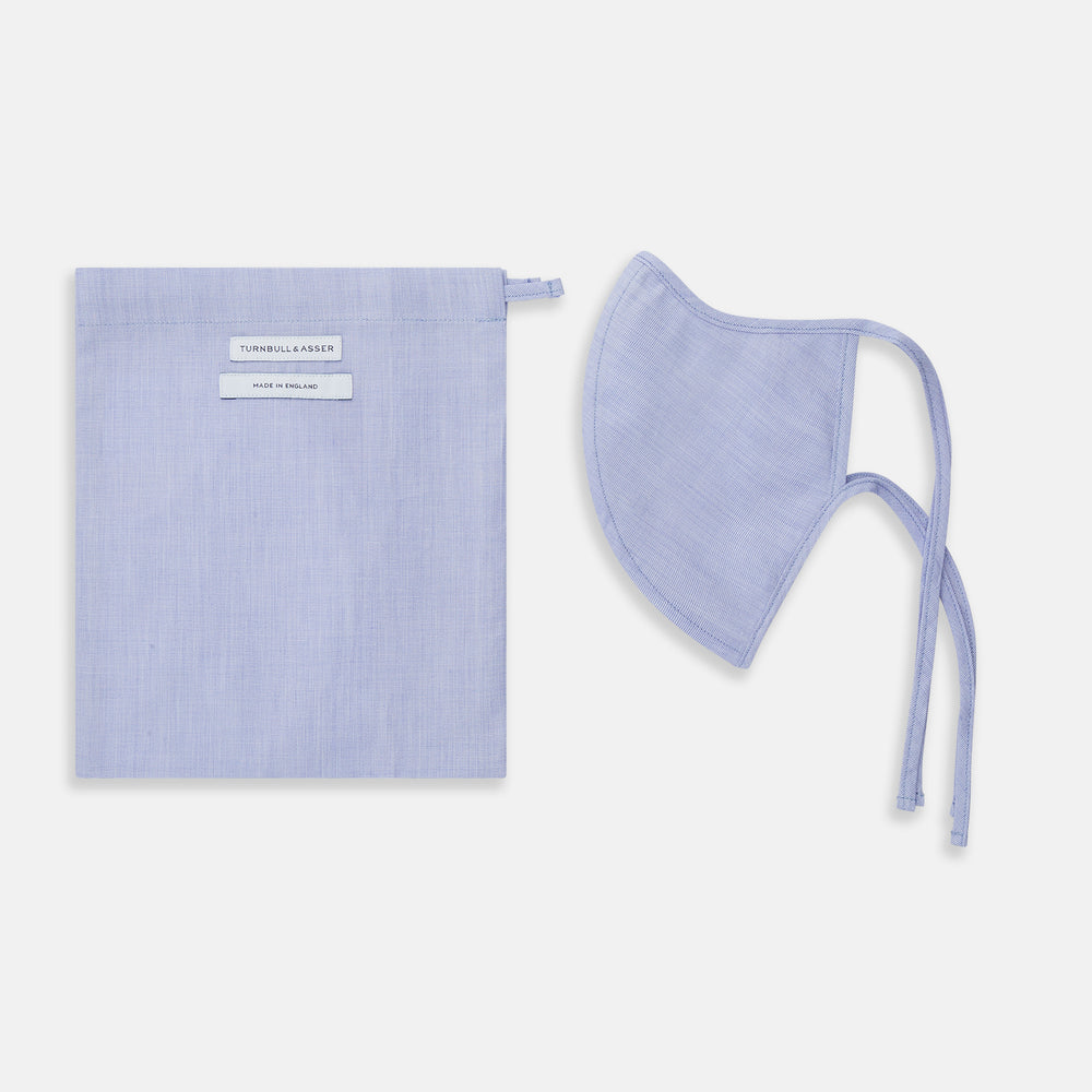 The Turnbull & Asser Plain Pale Blue Commuter Mask with 3 Viroformula™ filters features adjustable ear loops and side ties—ideal for daily use, shown against a white background.