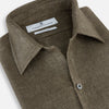 View 2 of product The Olive Linen Windsor Shirt by Turnbull & Asser features long sleeves, a classic Windsor collar, buttoned cuffs, and a straight hem—expertly crafted in Britain and shown against a white background.