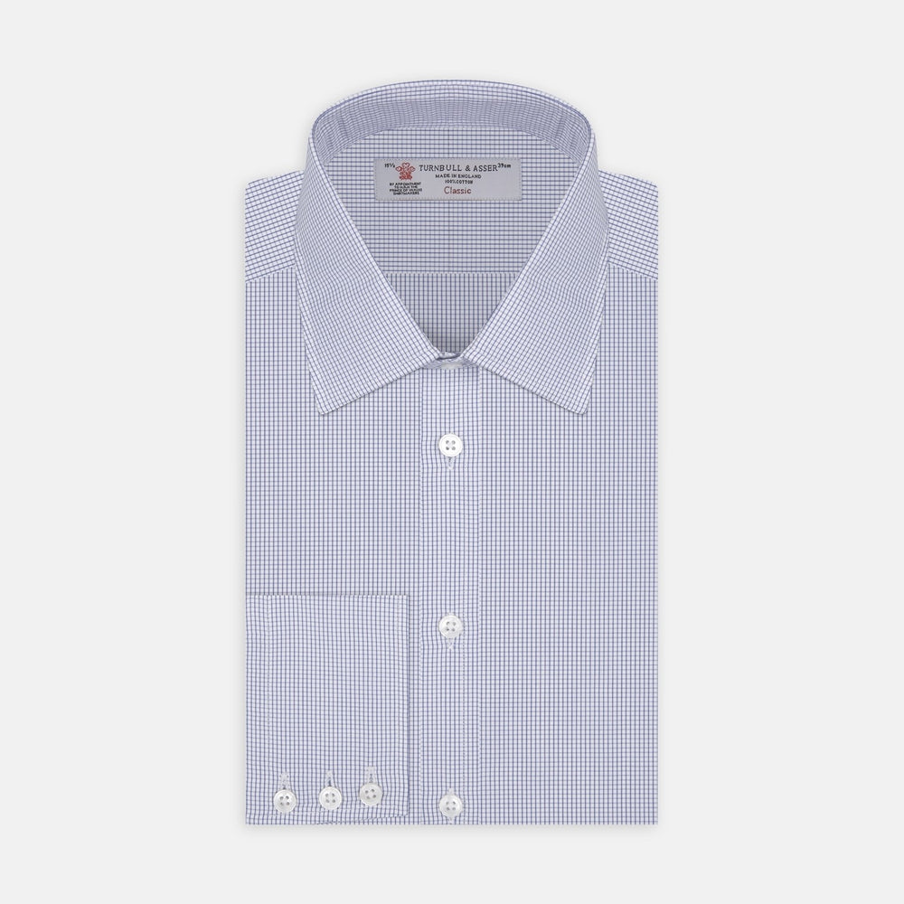 A circular close-up of Turnbull & Asser’s Blue Grid Check Cotton Fabric shows its white base with evenly spaced blue grid lines, bordered by a gray ring on a white background.
