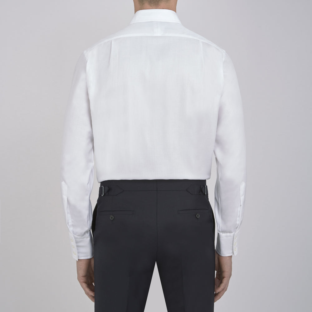 The Turnbull & Asser White Herringbone Superfine Cotton Shirt with T&A collar and 3-button cuffs is perfect for pairing with statement ties or elevating minimalist looks.