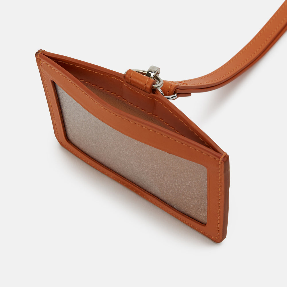 A tan Turnbull & Asser ID Card Holder made of Italian leather, featuring a matching lanyard and small tag. "Turnbull & Asser" is elegantly embossed in gold on the front, set against a plain white background.