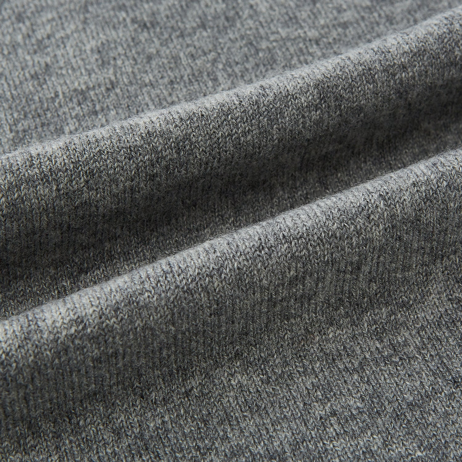 View 3 of product The Turnbull & Asser Plain Grey Cashmere Knitted Scarf is shown draped against a white background, highlighting its soft luxury and timeless appeal.