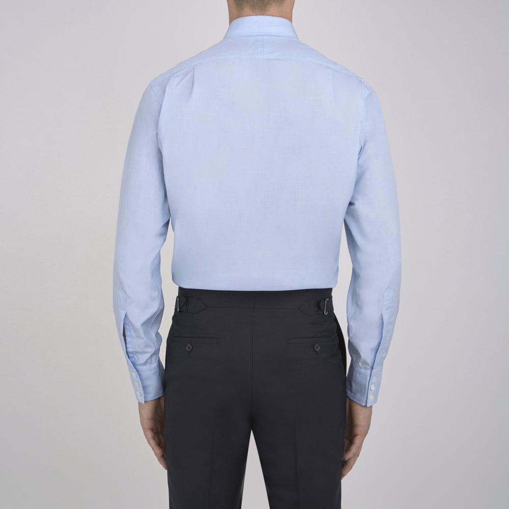The Turnbull & Asser Light Blue End-on-End Shirt features a T&A collar and 3-button cuffs, neatly displayed against a plain white background—ideal for pairing with a navy suit.