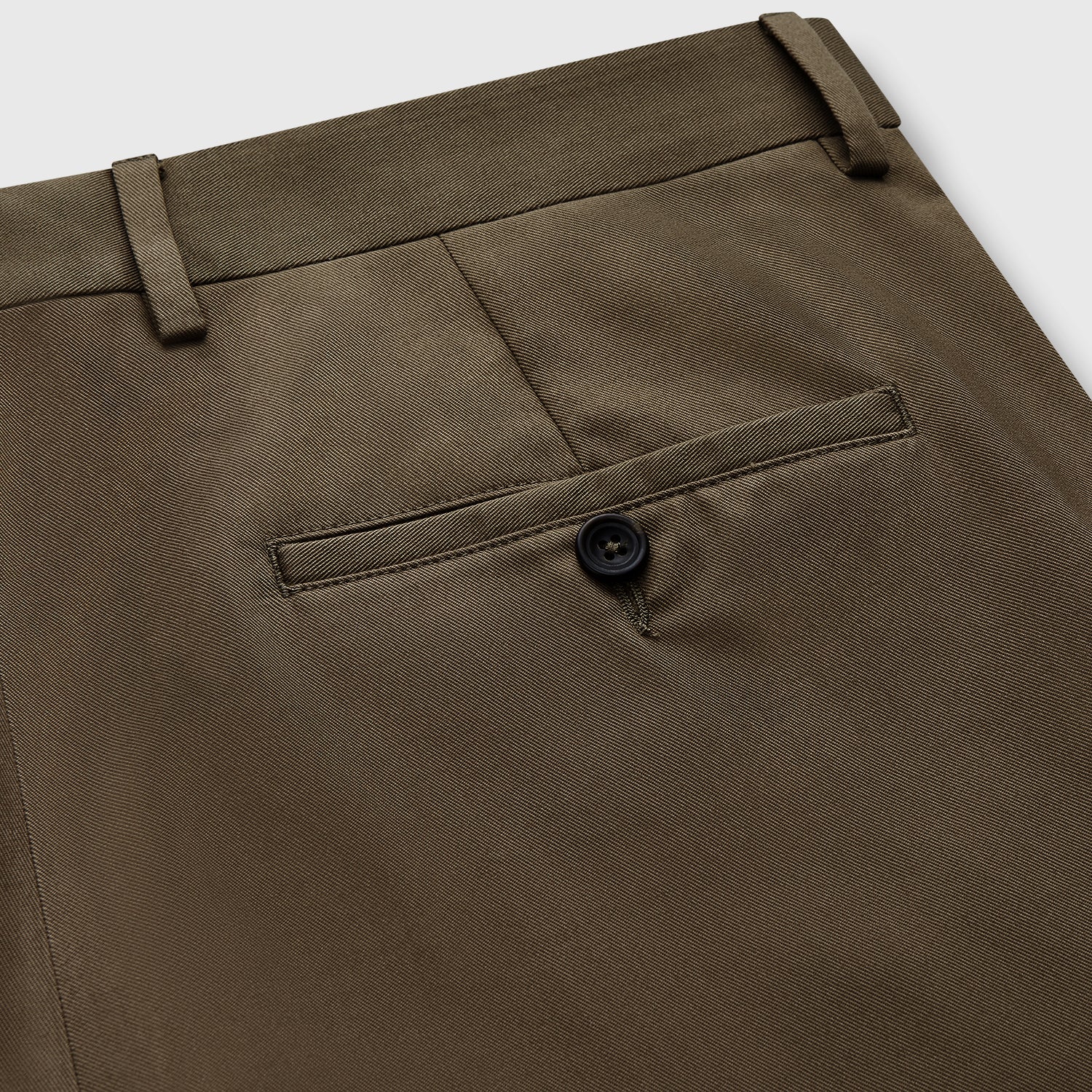 View 2 of product Close-up of the back of Turnbull & Asser's Khaki Green Cotton Twill Manson Trouser, featuring a single buttoned back pocket, belt loops, and fine stitching details—a menswear essential.