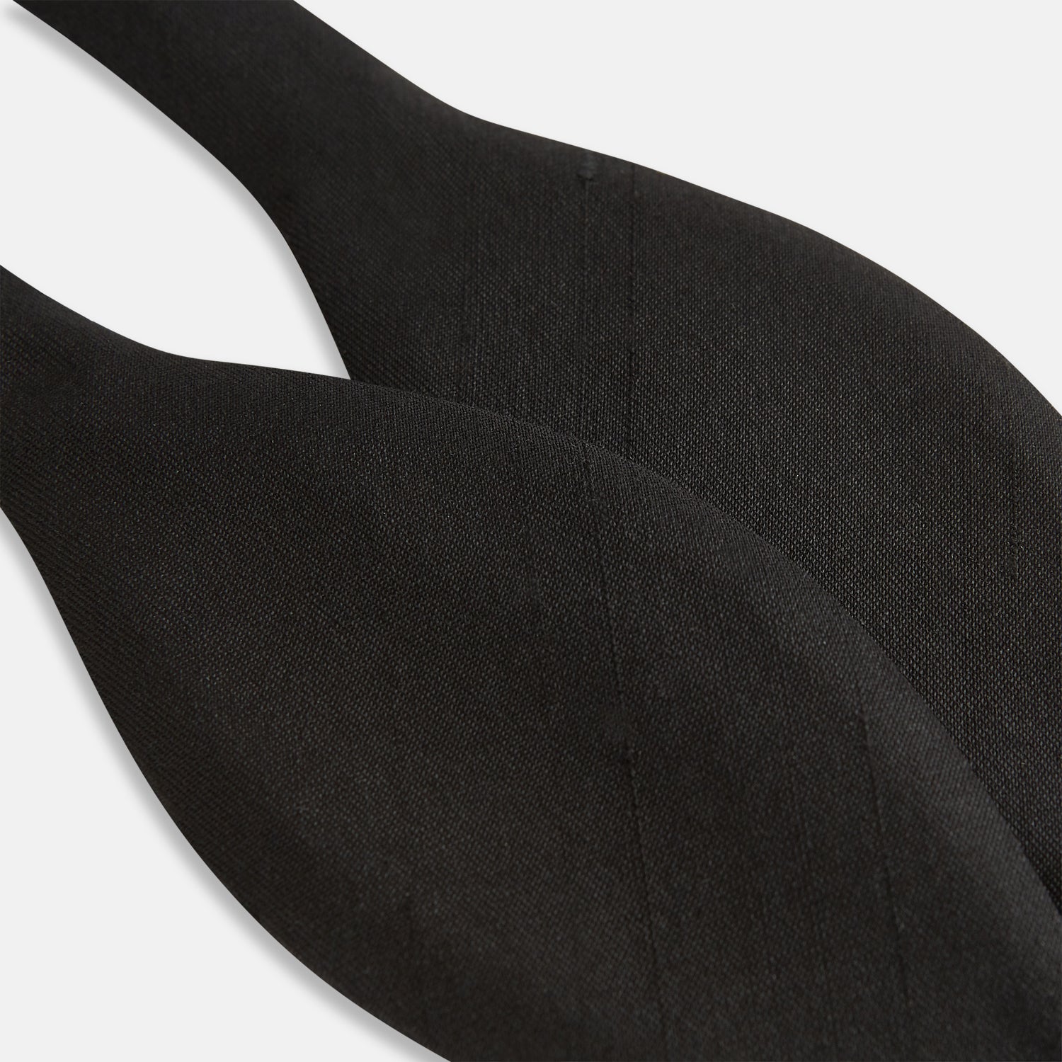 Image 4 of product The Casino Royale Bow Tie by Turnbull & Asser, as seen on James Bond, is a classic black Shantung silk bow tie with a smooth, slightly shiny finish, shown against a plain white background.