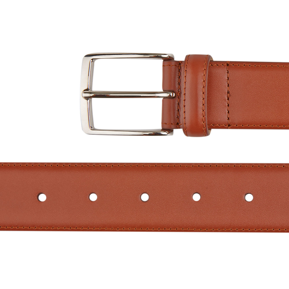 A Red Classic Calf Leather Satin Belt by Turnbull & Asser, coiled neatly with a silver rectangular buckle, set against a plain white background.