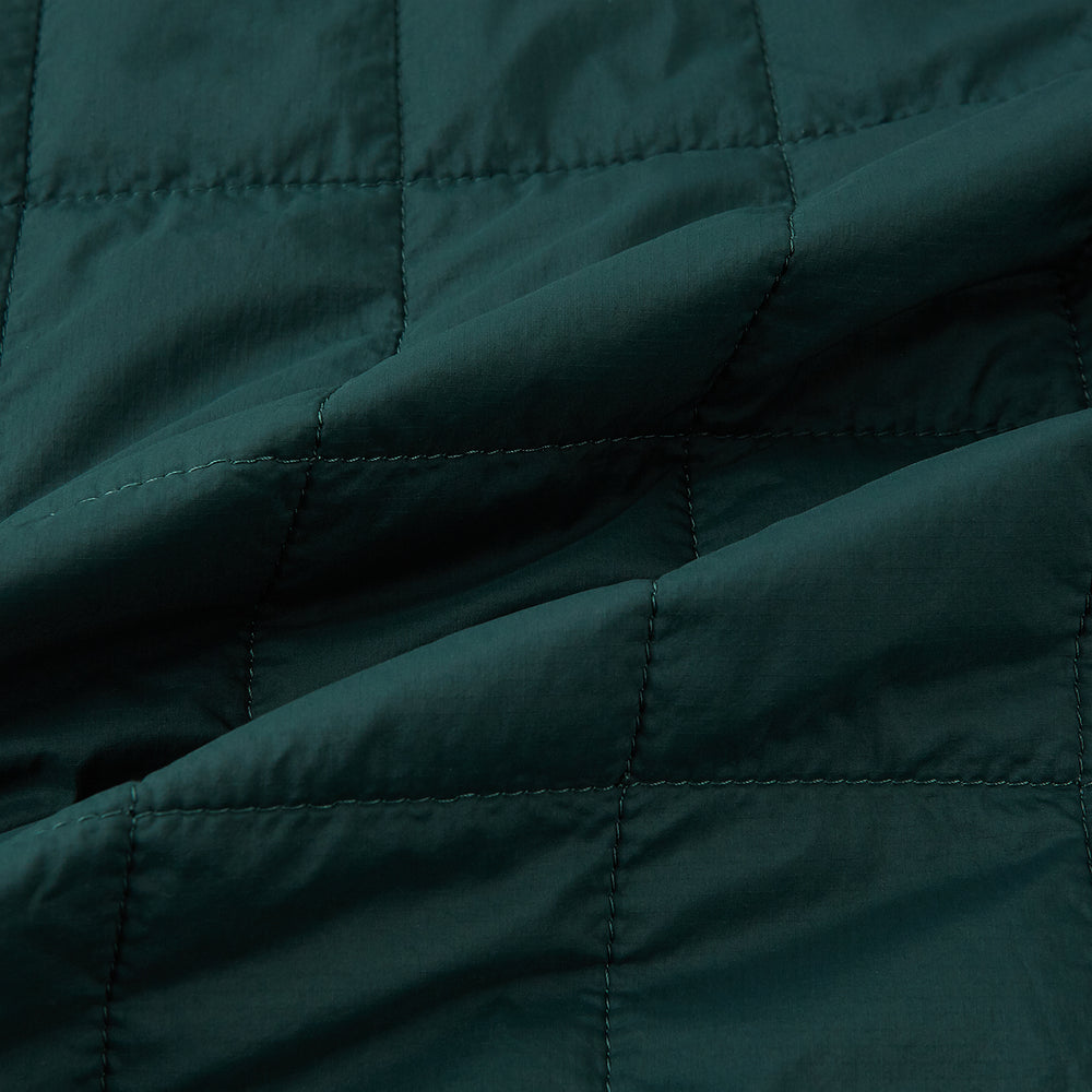 Turnbull & Asser Forest Green Quilted Gilet features a front zipper, two zippered side pockets, and a small chest pocket. Shown against a white background, it's a stylish lightweight layer for any season.