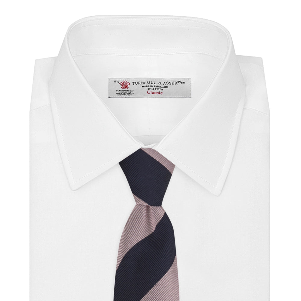 The Turnbull & Asser Navy and Rose Block Stripe Repp Silk Tie, crafted from luxurious silk, features bold diagonal stripes and is displayed rolled up on a plain white background.