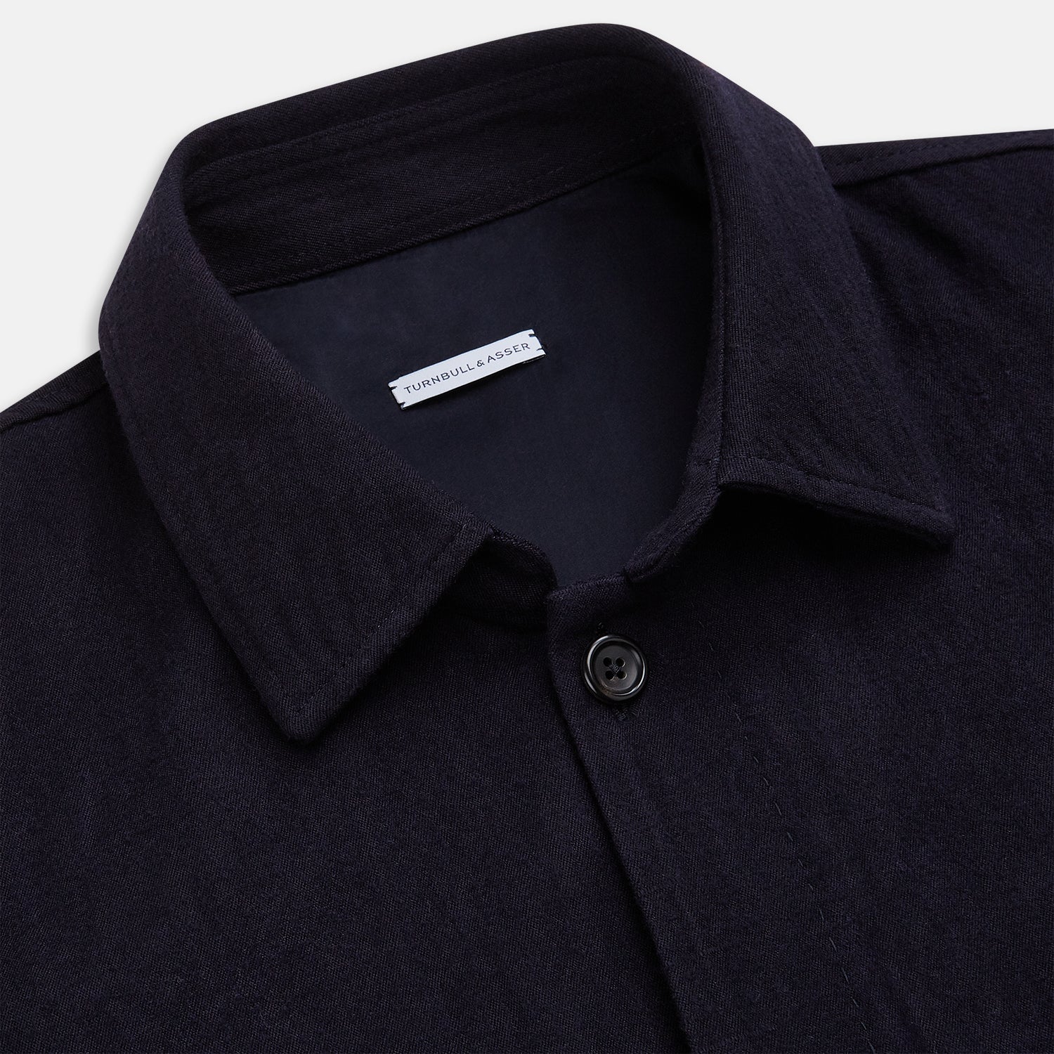 View 2 of product A navy button-up Primrose overshirt by Turnbull & Asser with a classic collar, two side pockets, a left chest pocket, and buttoned cuffs—an ideal blazer alternative, shown on a plain white background.