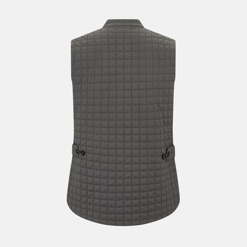 The Turnbull & Asser Shadow Grey Double-Breasted Quilted Gilet features a sleeveless design, asymmetrical collar, side zip pockets, slanted chest pocket, grid pattern, and modern black buttons—perfect for layered dressing.