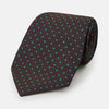 View 1 of product The Turnbull & Asser Turquoise and Forest Green Micro Dot Silk Tie is rolled up, showcasing evenly spaced micro dots on silk, displayed against a plain white background.