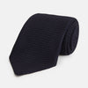View 1 of product The Turnbull & Asser Midnight Blue Knitted Tie, elegantly textured and displayed on a white background, is a versatile addition to any gentleman's wardrobe.