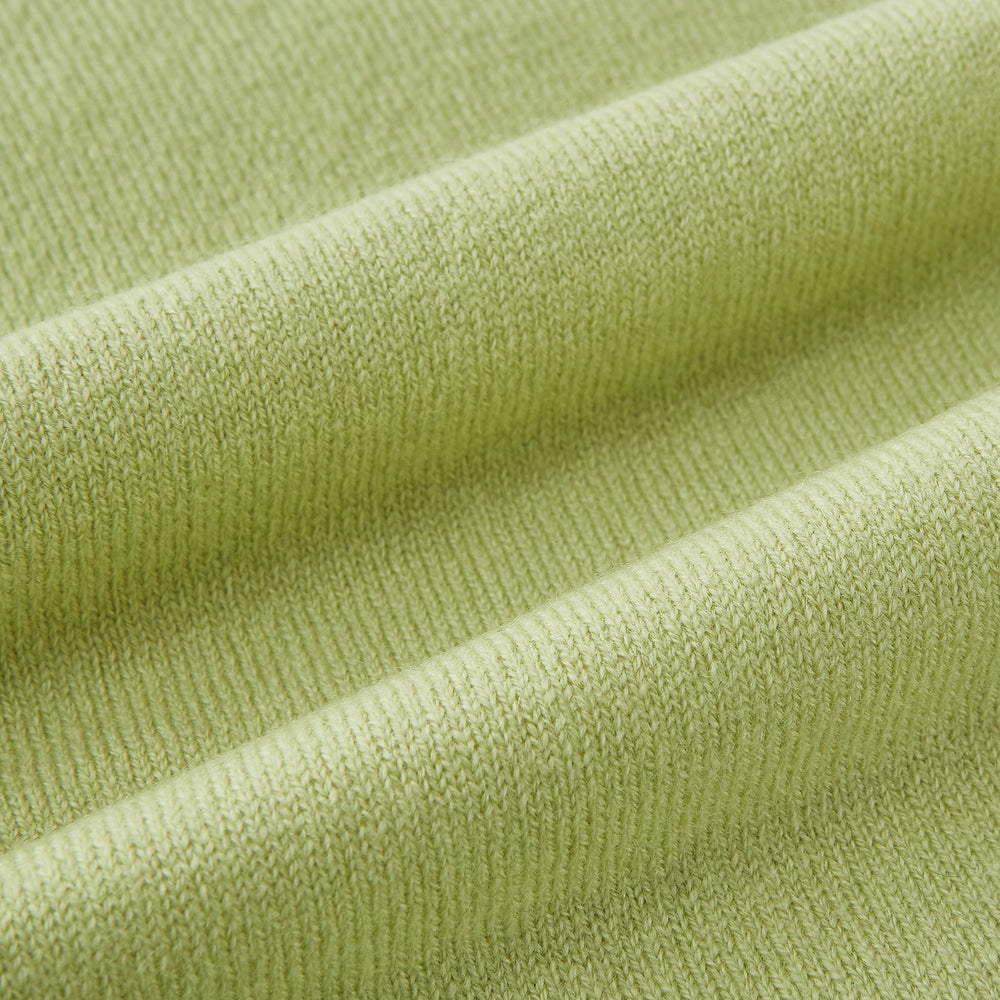 The Plain Canary Yellow Cashmere Knitted Scarf from Turnbull & Asser is a soft, premium accessory, elegantly draped against a white background—an essential addition to any wardrobe.