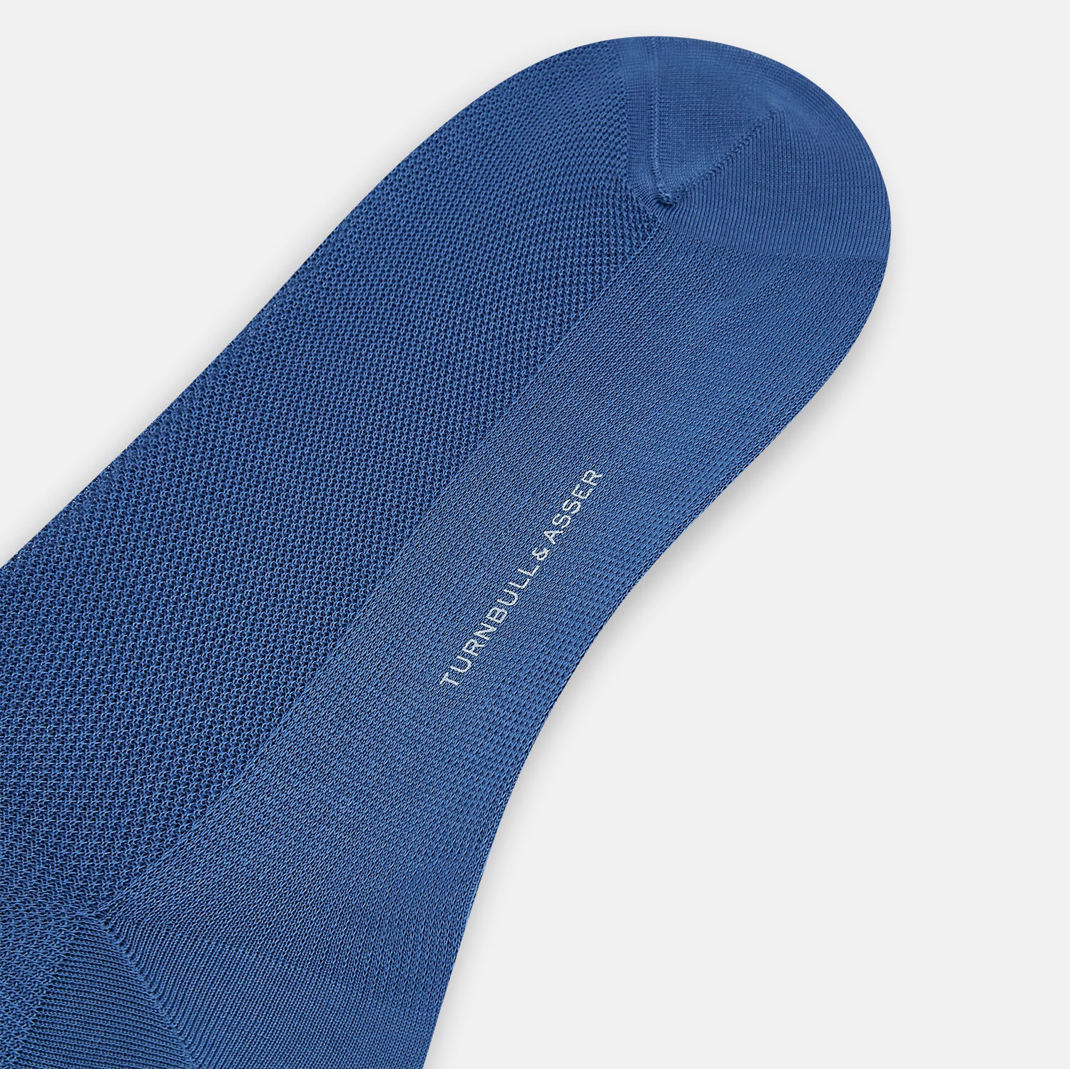 View 3 of product The Azzurro Micro Knit Mid-Length Sock by Turnbull & Asser, crafted from mercerised Egyptian cotton, is shown upright on a light background with a smooth texture, micro knit pattern, and slightly ribbed top band.