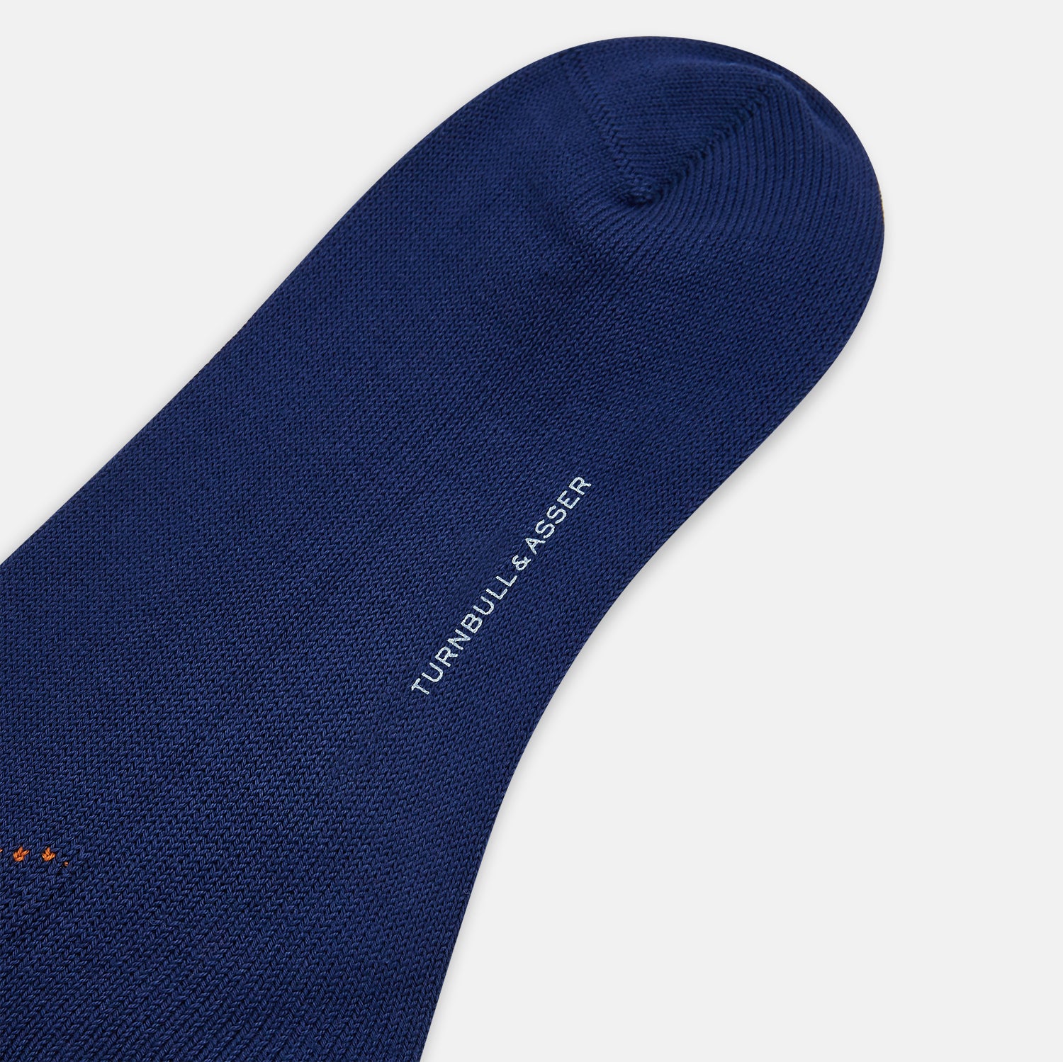 View 3 of product Turnbull & Asser’s Royal Blue Check Mid-Length Sock features a blue base with red, orange, and blue checks on the calf, shown against a plain white background.