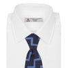 View 2 of product The Turnbull & Asser Navy and Light Blue Striped Zigzag Silk Tie features a striking zigzag pattern—a stylish accessory for the modern gentleman.
