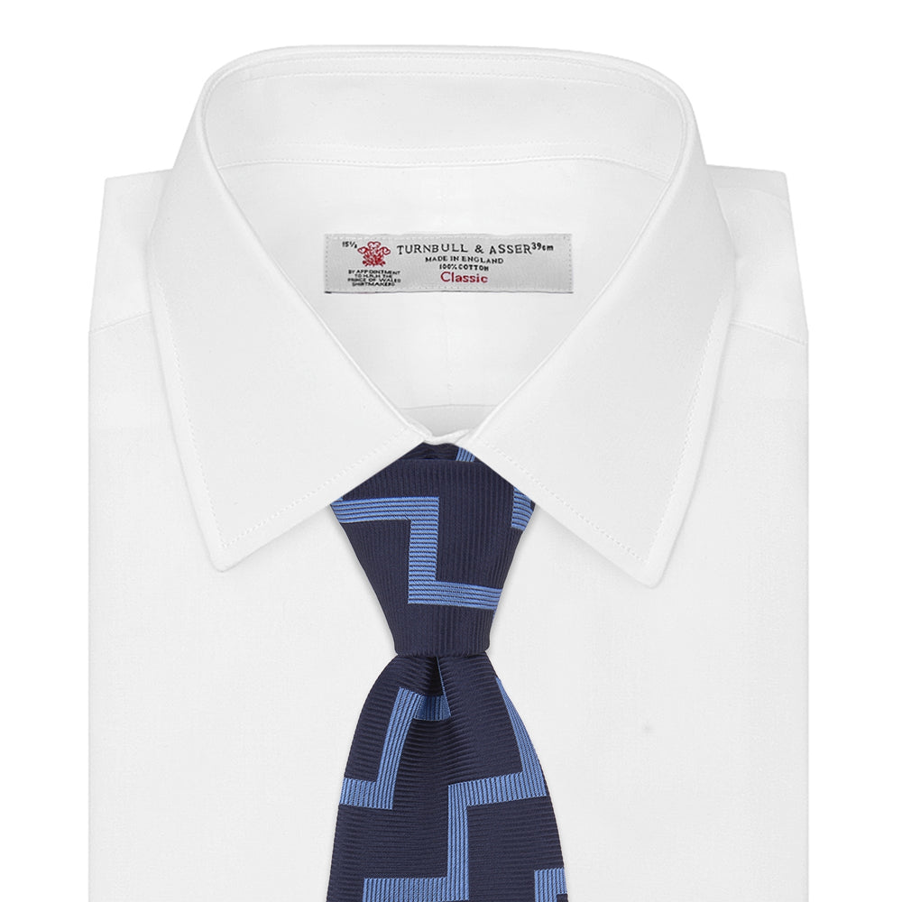 The Turnbull & Asser Navy and Light Blue Striped Zigzag Silk Tie features a striking zigzag pattern—a stylish accessory for the modern gentleman.