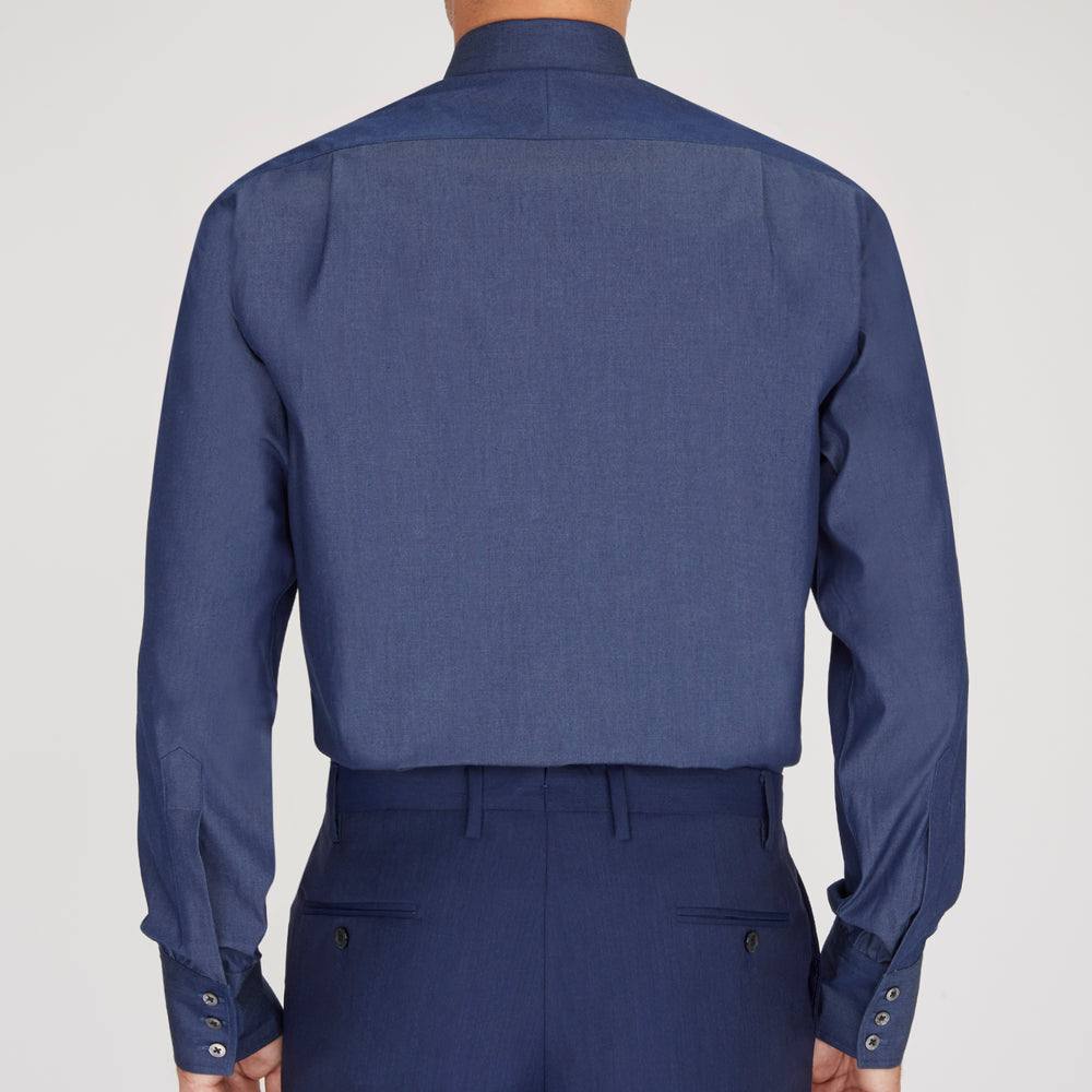 The Turnbull & Asser Dark Blue Denim-Cashmere Shirt features a Regent collar, long sleeves, and 3-button cuffs, neatly folded and displayed on a plain light background.