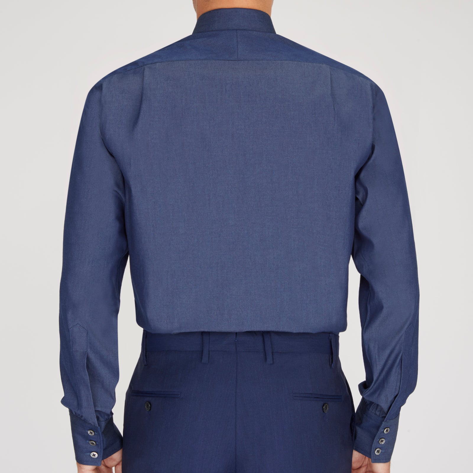 View 3 of product The Turnbull & Asser Dark Blue Denim-Cashmere Shirt features a Regent collar, long sleeves, and 3-button cuffs, neatly folded and displayed on a plain light background.