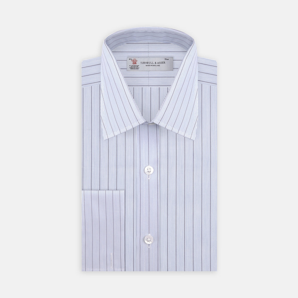 Close-up of Turnbull & Asser Blue and Navy Fine Stripe Cotton Fabric, showcasing alternating thin and thick navy stripes on light blue cotton, displayed within a circular frame on a white background.