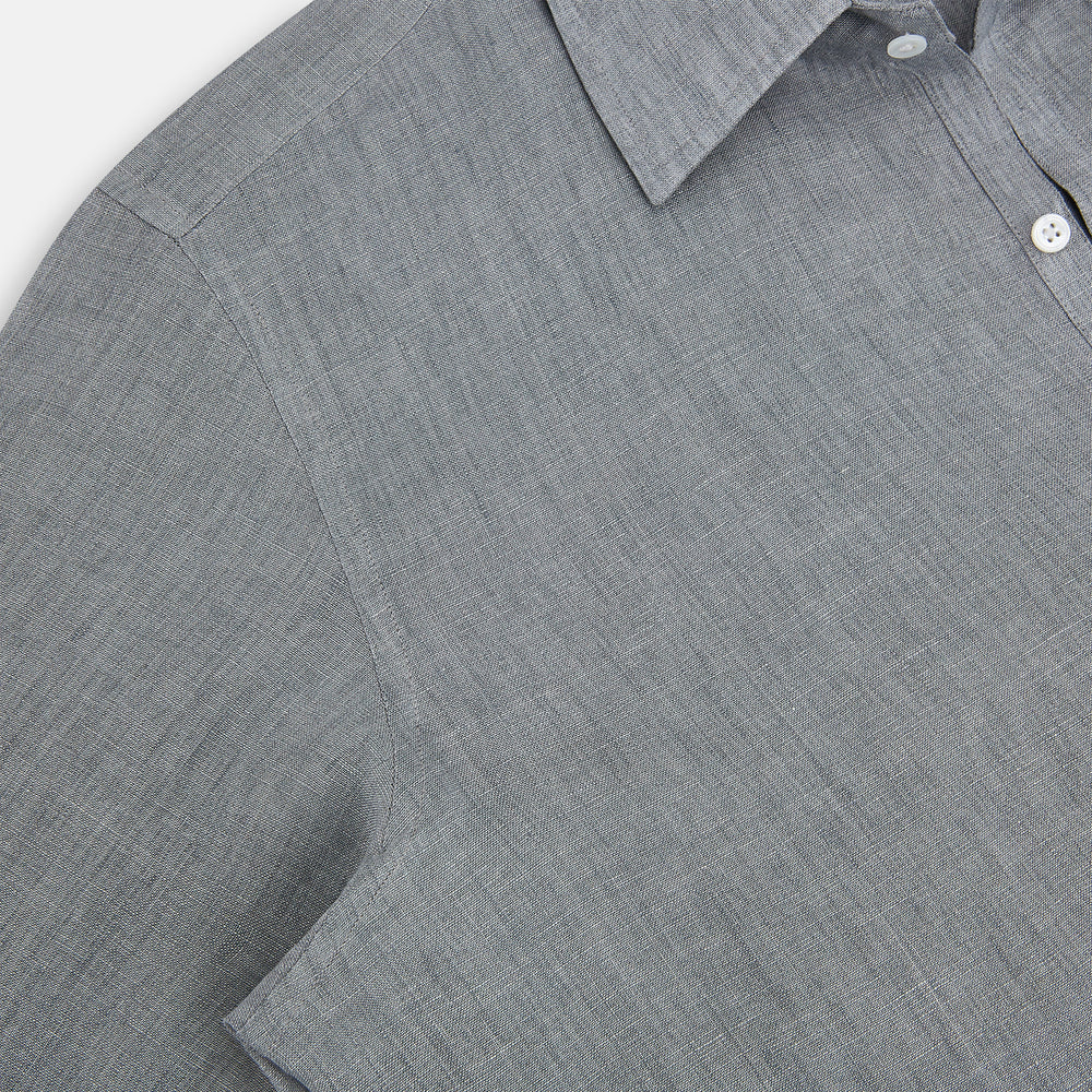 The Grey Linen Westminster Shirt by Turnbull & Asser is a long-sleeve, light gray button-up with a formal collar and white buttons, highlighting British craftsmanship and laid flat on a white background.